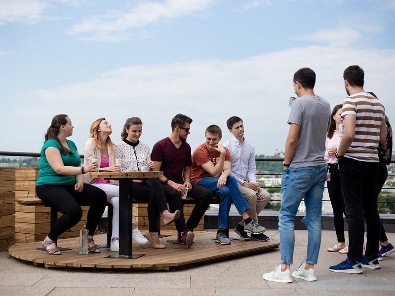 Team of software testers and developers enjoying time together on the terrace
