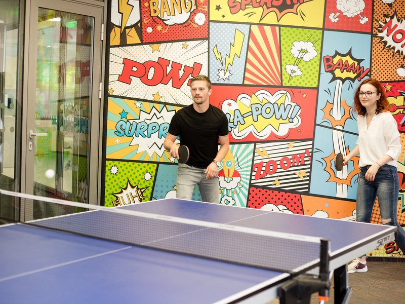 Two Centric colleagues from Managed Services taking a break playing table tennis ping pong