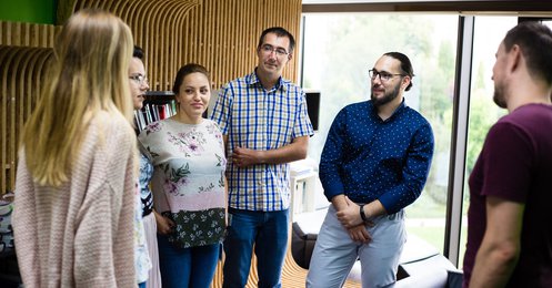 Centric Iasi team in the library discussing a project - developer - tester - scrum master