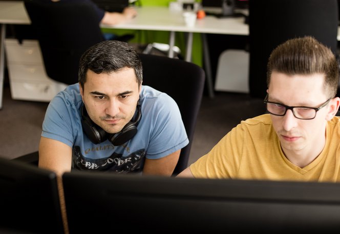 Two software testers sitting together at the computer