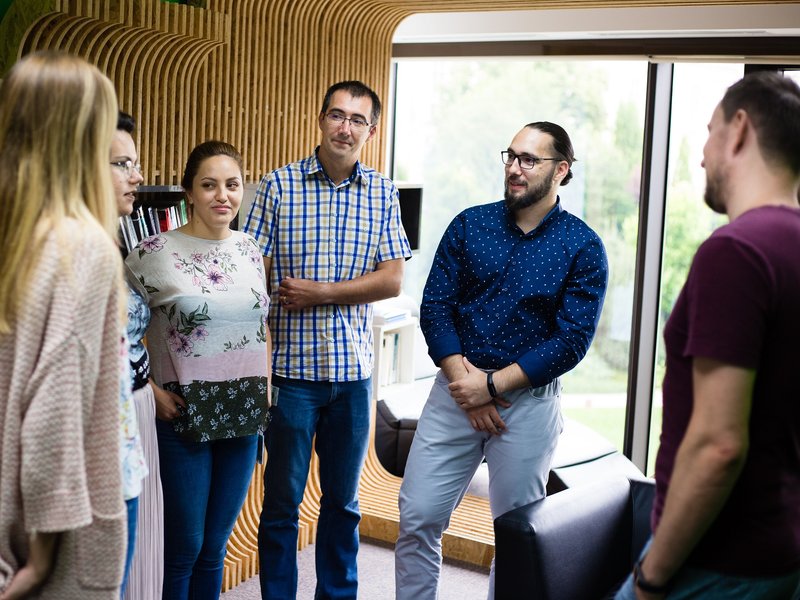 Team of software developers full stack developers and software testers in a meeting in the library