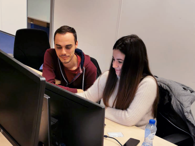 Software testers working at a computer together