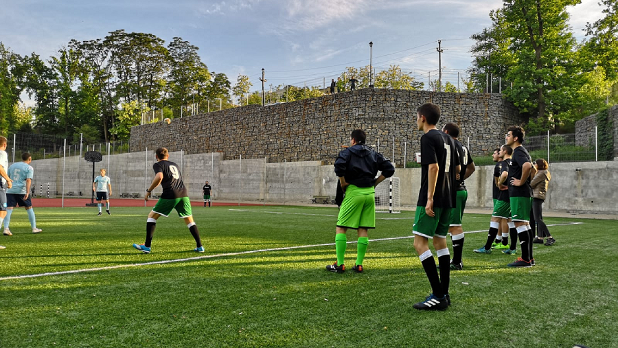centric colleagues playing football together