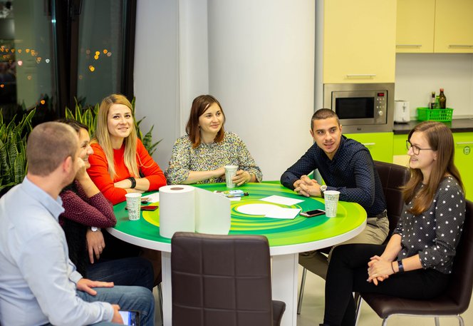 Centric colleagues sitting together talking after work