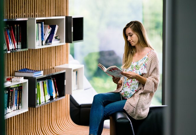 Centric Iasi software developer learning reading a book in the library