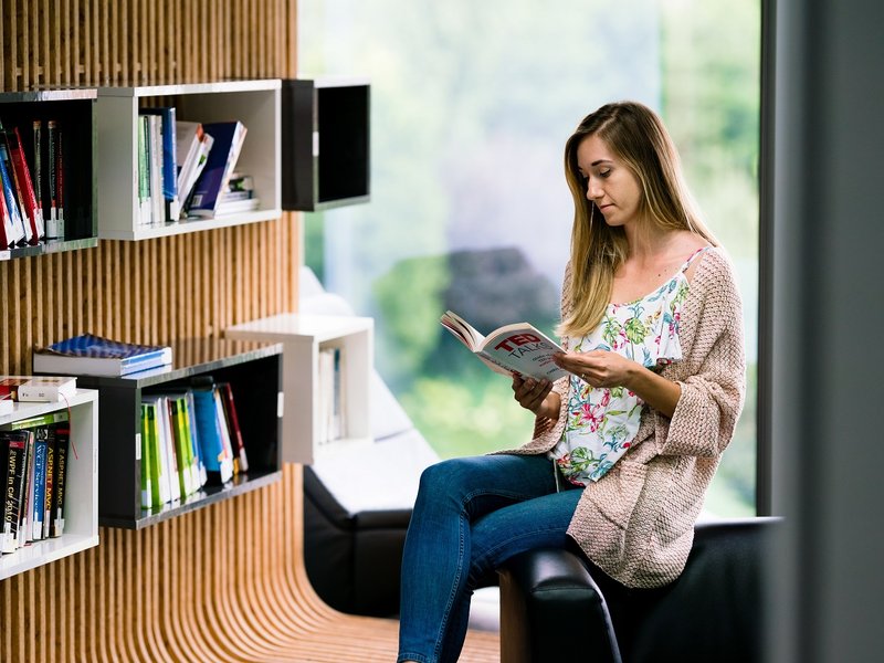 Centric Iasi software developer learning reading a book in the library