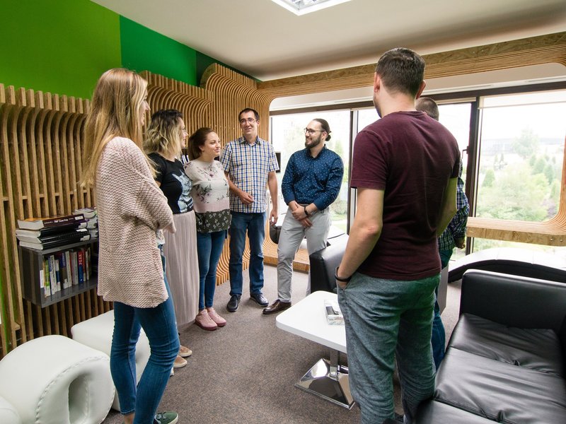 Team of software developers full stack developers and software testers in a meeting in the library
