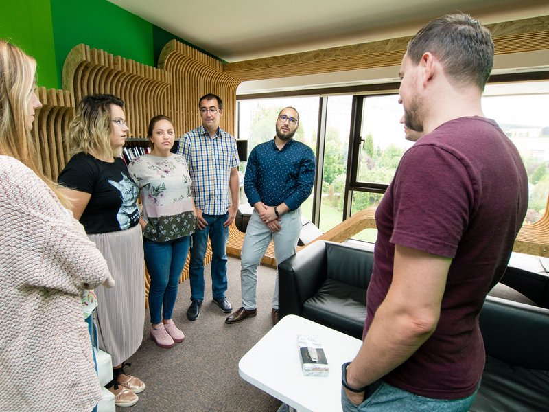 Team of software developers full stack developers and software testers in a meeting in the library