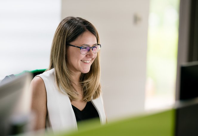 full stack developer smiling as she works on a software product