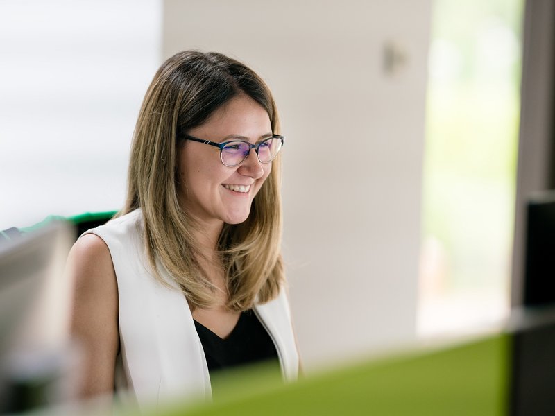 full stack developer smiling as she works on a software product