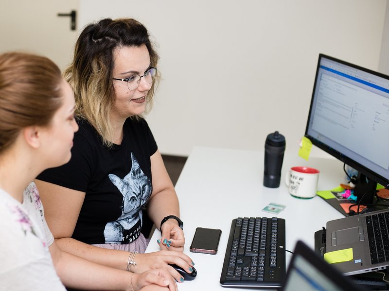 Two software testers sitting together at the computer