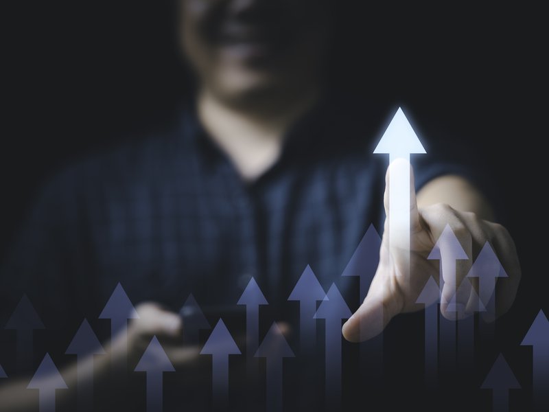 businessman-touching-glowing-increasing-arrow-business-profit-investment-growth-concept