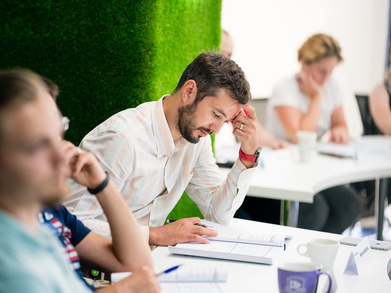 Centric DevOps Managed Services reading a book during a training